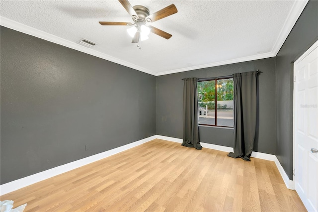 spare room featuring a textured ceiling, light hardwood / wood-style floors, ceiling fan, and ornamental molding