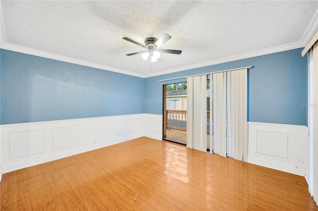 unfurnished room with a textured ceiling, hardwood / wood-style flooring, and crown molding