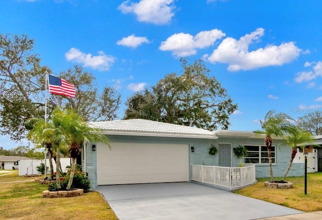 ranch-style house with a garage and a front lawn