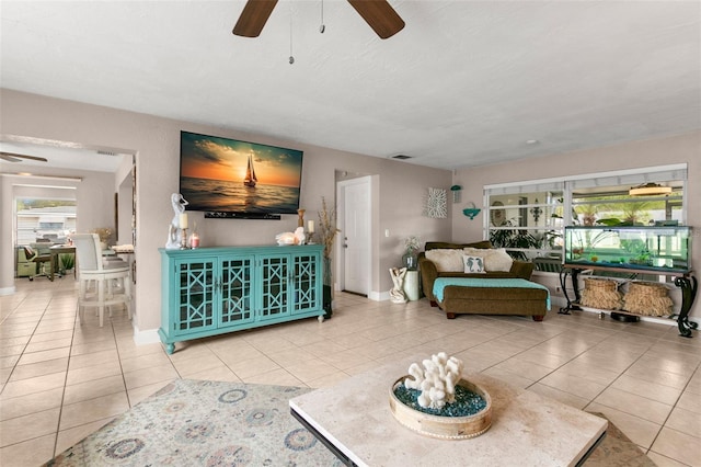 tiled living room featuring ceiling fan