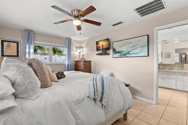 tiled bedroom with ensuite bath and ceiling fan