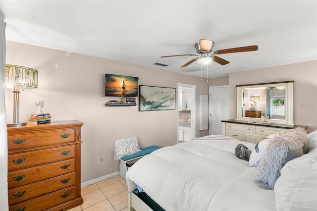 tiled bedroom with ensuite bathroom and ceiling fan