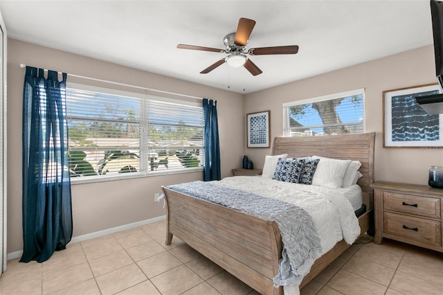 bedroom with ceiling fan and light tile patterned floors