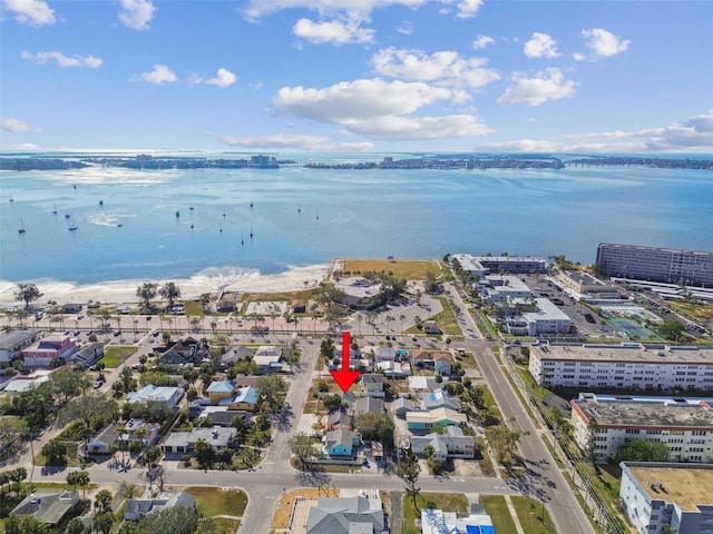 birds eye view of property with a water view and a beach view