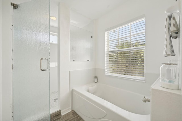 bathroom featuring hardwood / wood-style floors and shower with separate bathtub