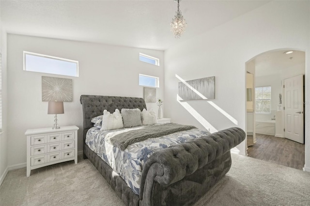 carpeted bedroom with vaulted ceiling and multiple windows