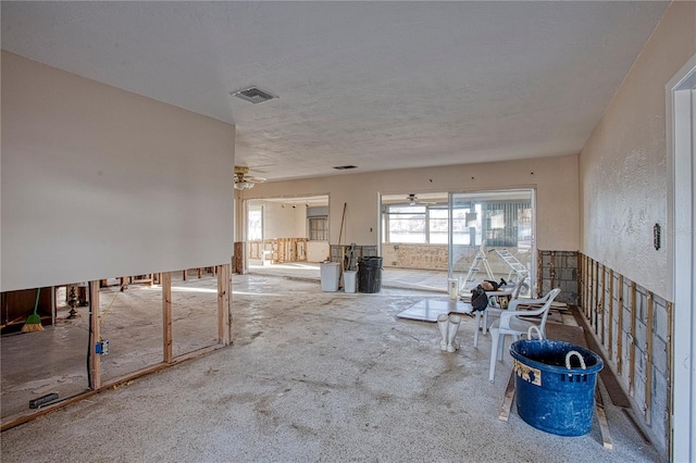 miscellaneous room featuring carpet flooring, a textured ceiling, and ceiling fan