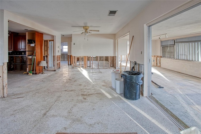 unfurnished living room featuring ceiling fan