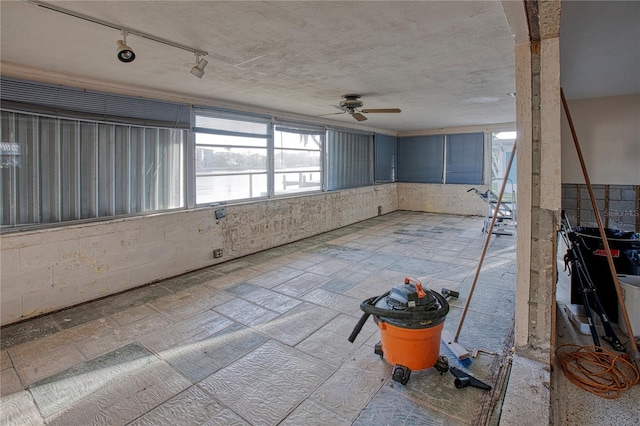 interior space with ceiling fan