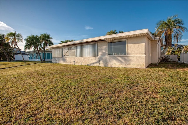 view of property exterior with a lawn