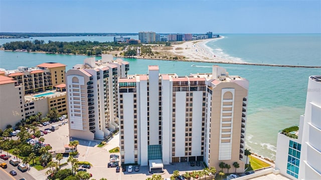 birds eye view of property with a beach view and a water view