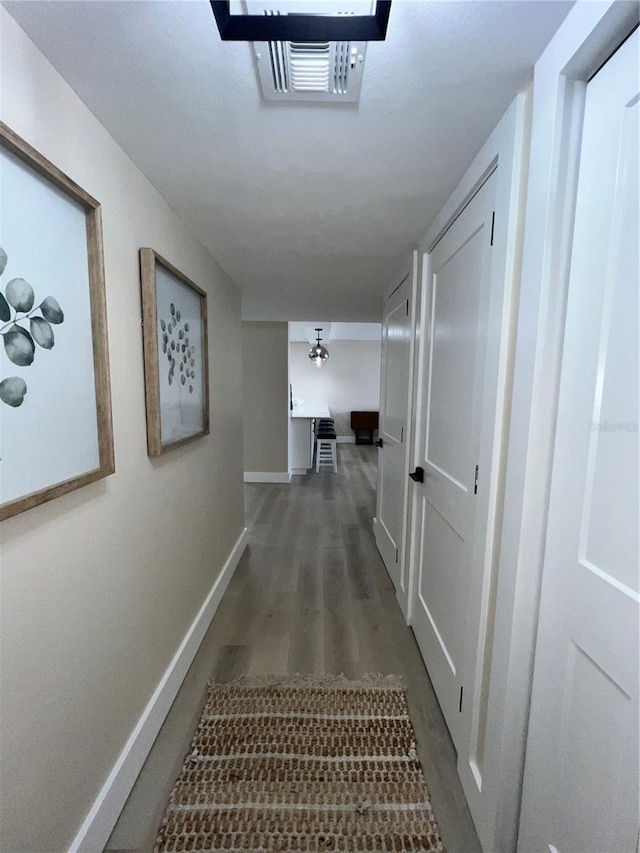 corridor featuring dark hardwood / wood-style floors