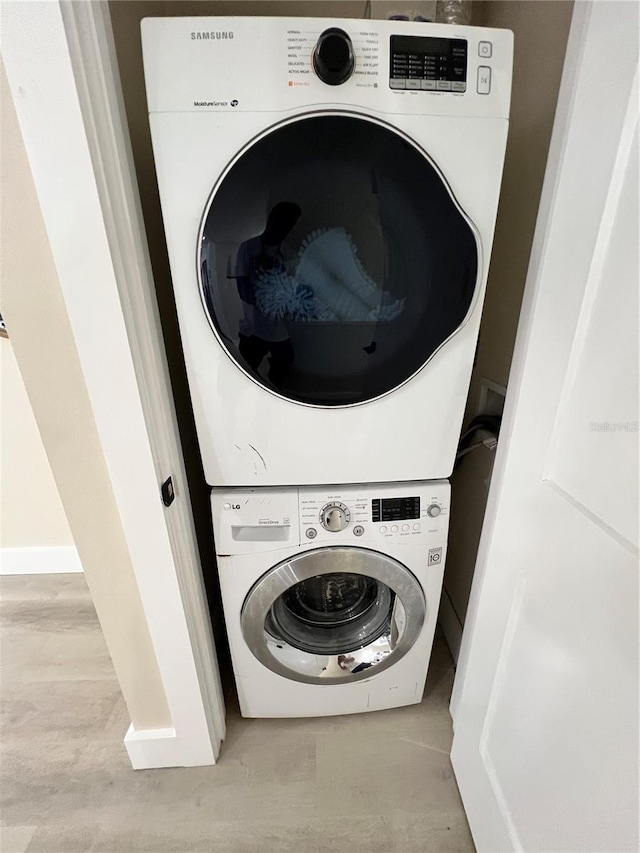 laundry room featuring stacked washer and clothes dryer