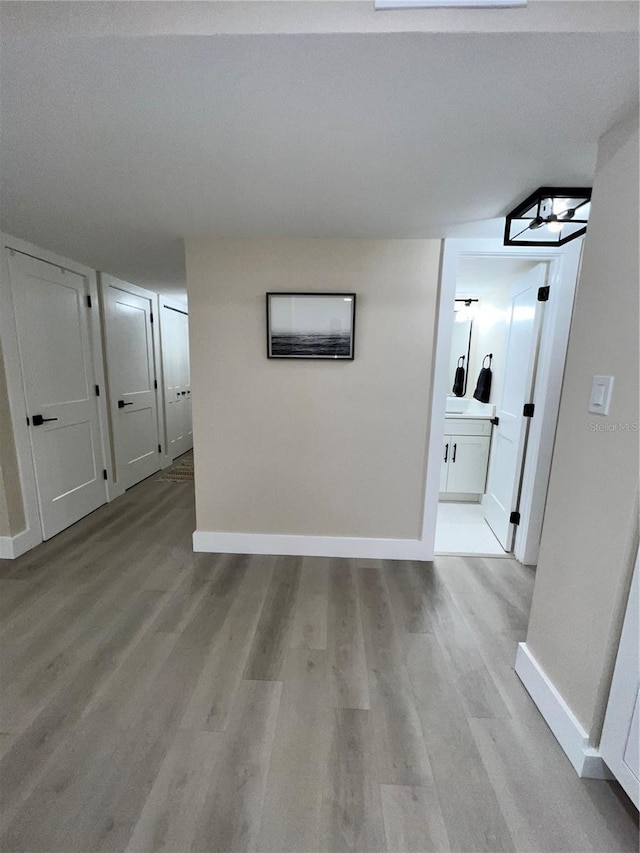 hallway with light hardwood / wood-style floors