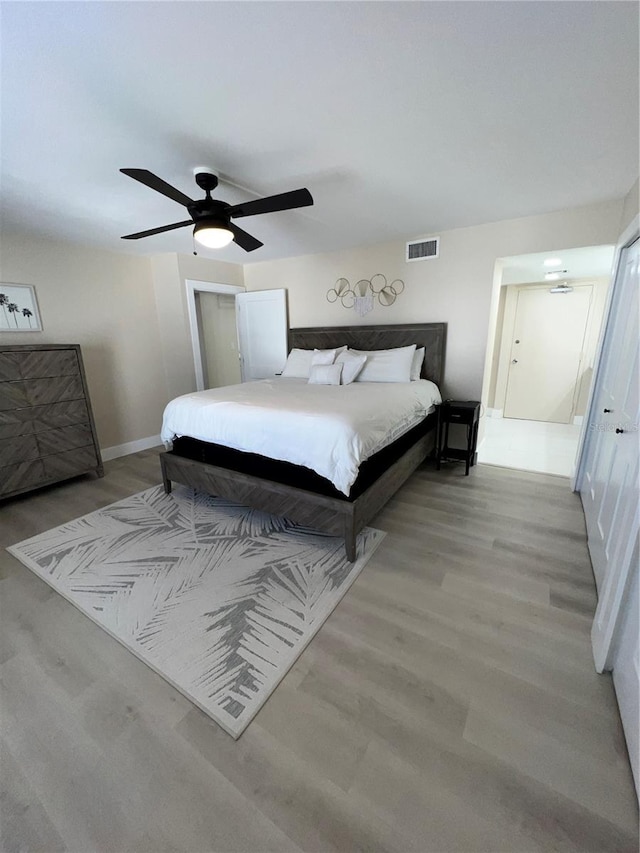 bedroom with ceiling fan and light wood-type flooring