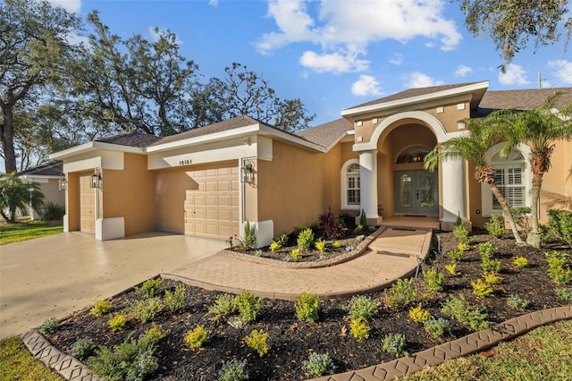 view of front of house featuring a garage and french doors