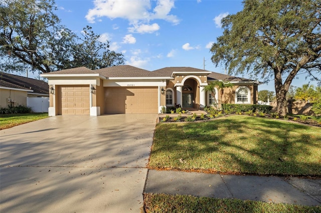 view of front facade with a garage and a front lawn