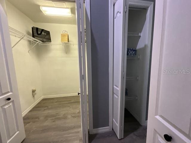 spacious closet with wood finished floors