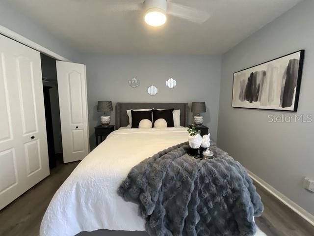 bedroom featuring dark wood-style floors, ceiling fan, and baseboards