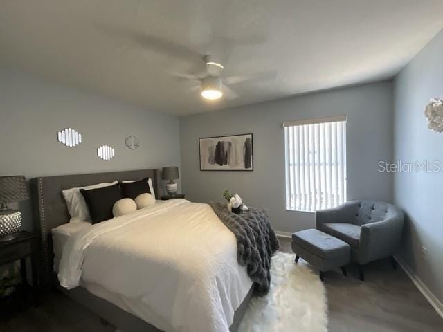 carpeted bedroom with a ceiling fan and baseboards