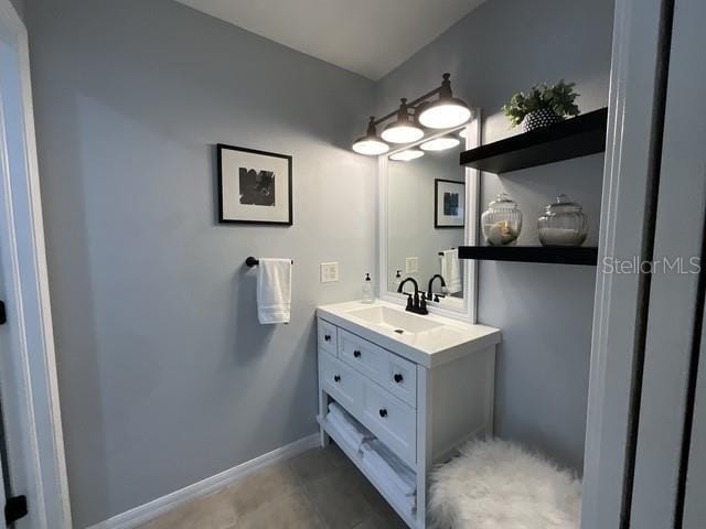 bathroom with vanity and baseboards