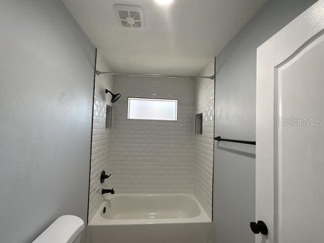 full bathroom featuring visible vents, toilet, and shower / tub combination