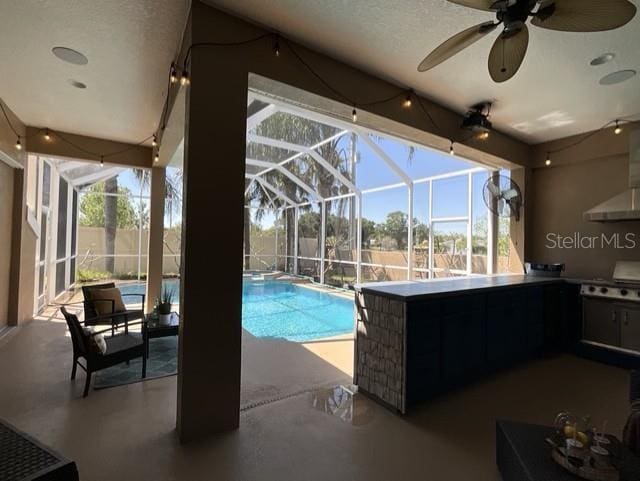 view of swimming pool with a patio, a fenced in pool, a lanai, fence, and a ceiling fan