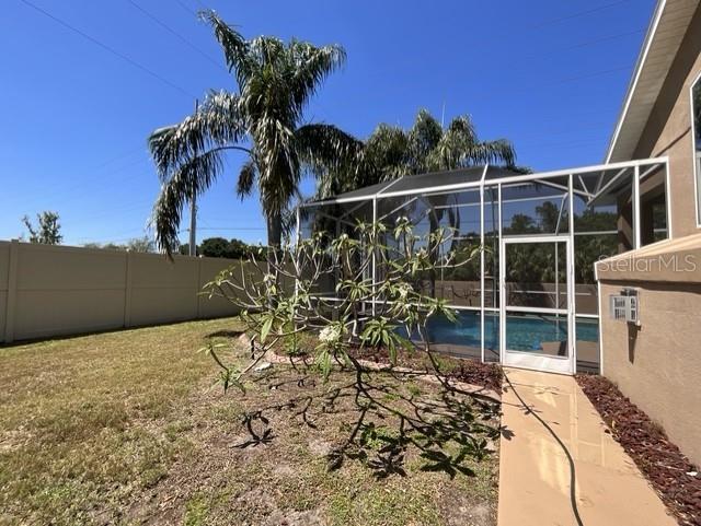 view of pool with a fenced in pool, a fenced backyard, and a lanai
