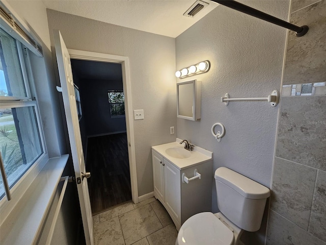 bathroom featuring tile patterned floors, vanity, and toilet