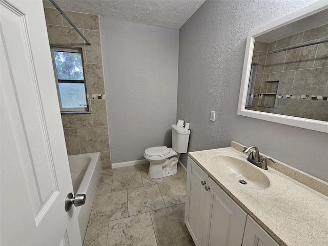 full bathroom with vanity, tiled shower / bath combo, a textured ceiling, and toilet