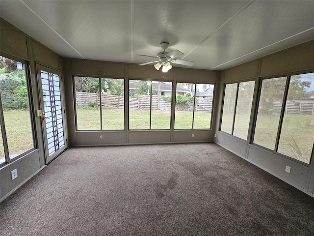 unfurnished sunroom featuring ceiling fan