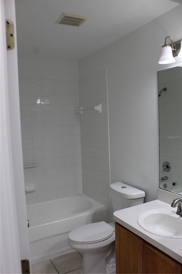 full bathroom featuring toilet, vanity, tile patterned floors, and tiled shower / bath combo