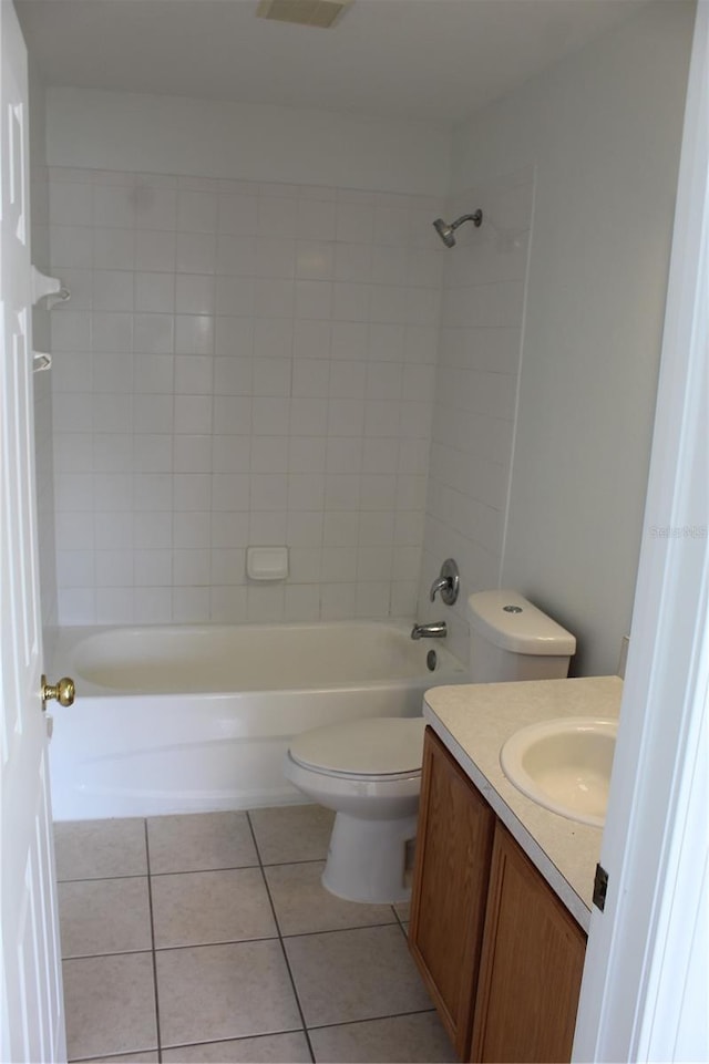 full bathroom with tile patterned flooring, vanity, toilet, and tiled shower / bath