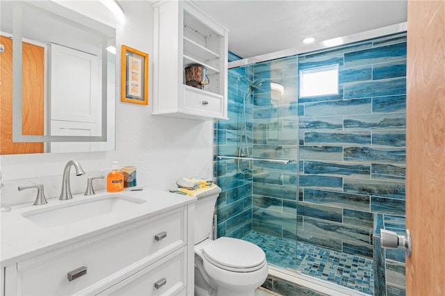 bathroom featuring vanity, toilet, and a shower with door