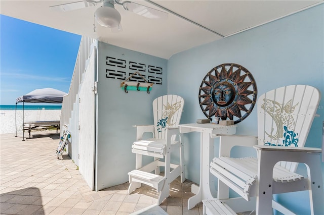 interior space with ceiling fan