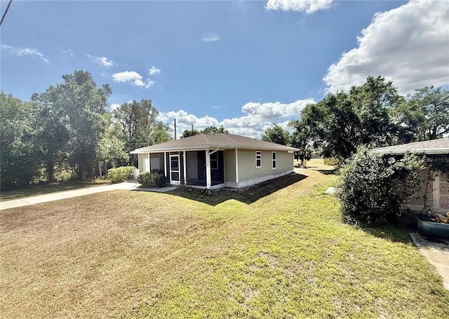exterior space featuring driveway and a lawn