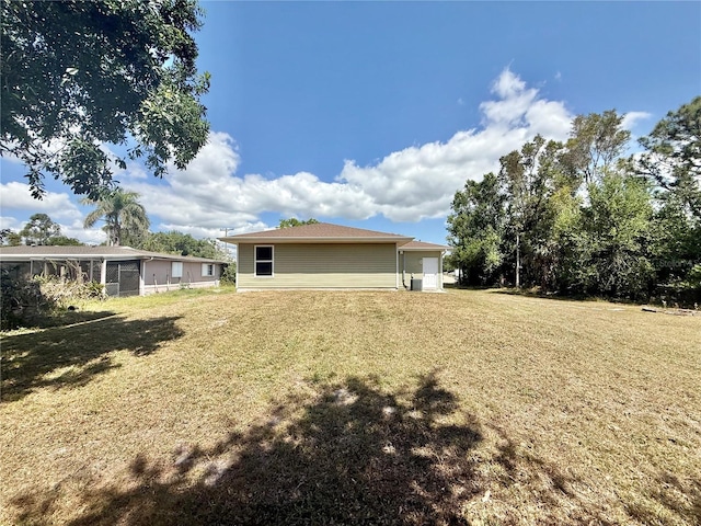 back of house featuring a lawn