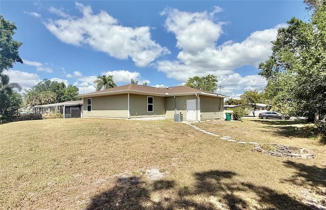 rear view of property with a lawn