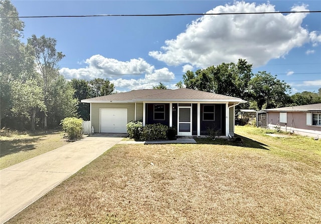 view of front facade with an attached garage, concrete driveway, and a front yard