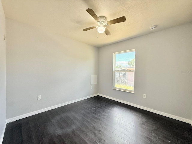 unfurnished room with dark wood-type flooring, baseboards, and ceiling fan