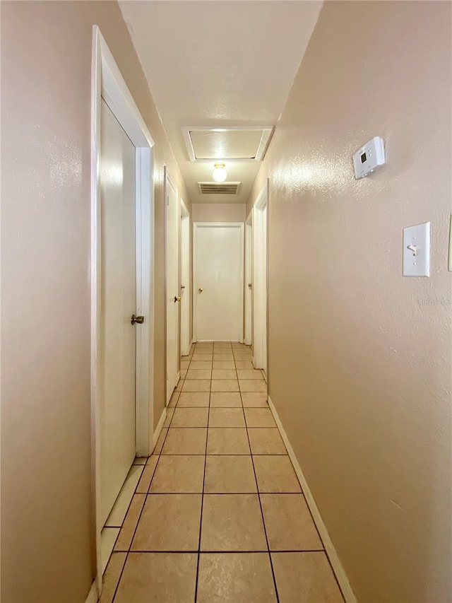 hallway with light tile patterned floors