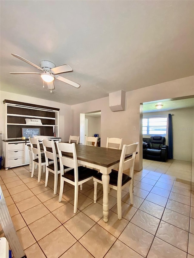 dining area with ceiling fan and light tile patterned flooring