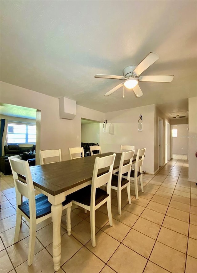 tiled dining room with ceiling fan