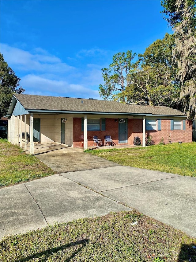 ranch-style home featuring a front yard and a carport