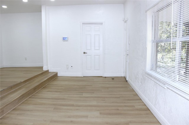 hallway with light hardwood / wood-style floors