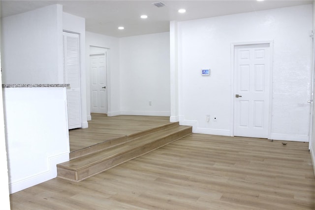 hallway with light hardwood / wood-style flooring