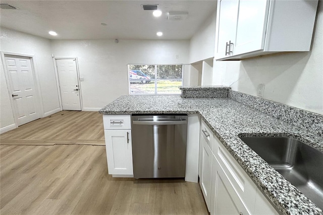 kitchen with dishwasher, light hardwood / wood-style flooring, white cabinetry, and sink