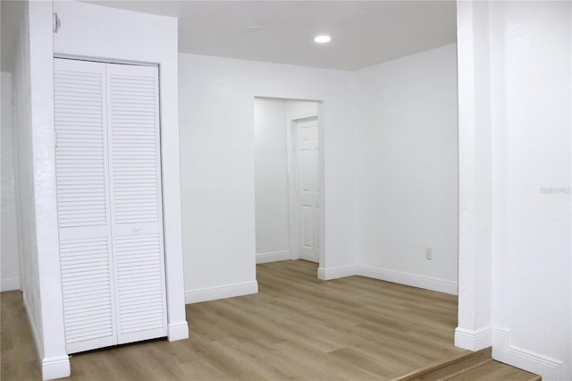 unfurnished bedroom with a closet and light wood-type flooring