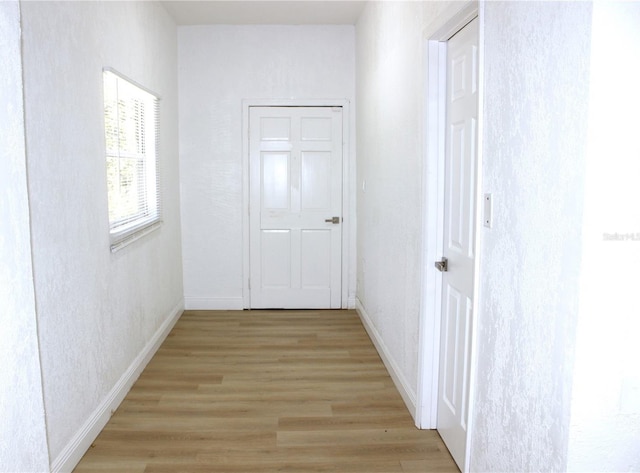 hall with light wood-type flooring