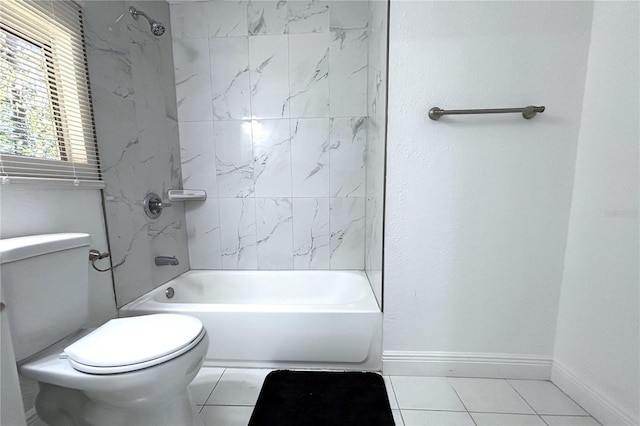 bathroom with tile patterned flooring, toilet, and tiled shower / bath